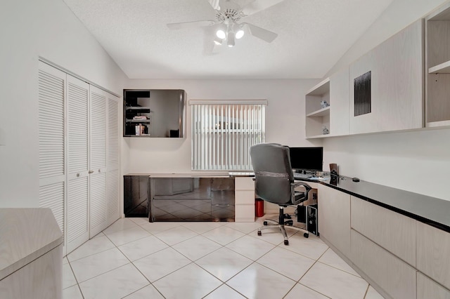 tiled home office featuring lofted ceiling, a textured ceiling, and ceiling fan