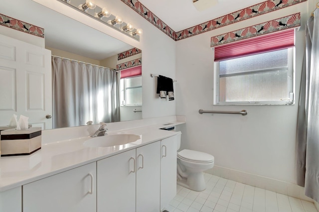 bathroom featuring toilet, vanity, and tile patterned flooring