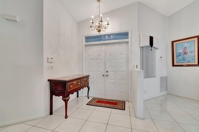 entryway featuring lofted ceiling, an inviting chandelier, and light tile patterned flooring