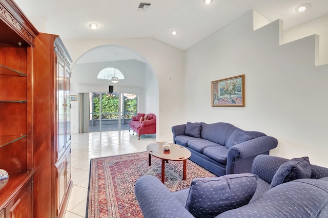 living room featuring lofted ceiling and light tile patterned floors