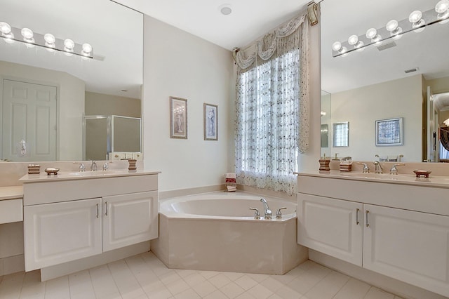 bathroom with shower with separate bathtub, tile patterned floors, and vanity