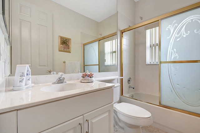 full bathroom featuring shower / bath combination with glass door, vanity, and toilet