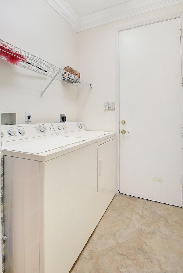 washroom featuring washer and dryer and crown molding