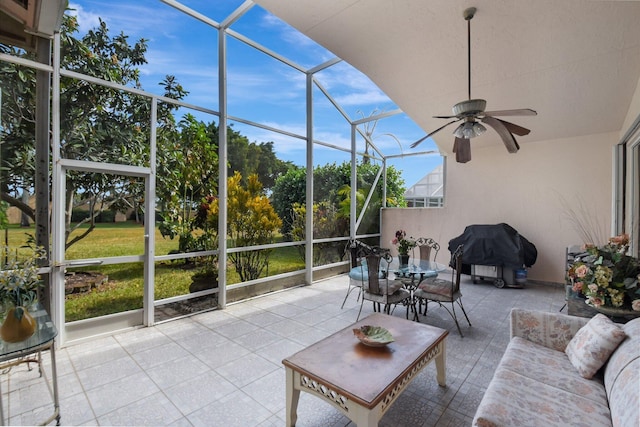 unfurnished sunroom with ceiling fan