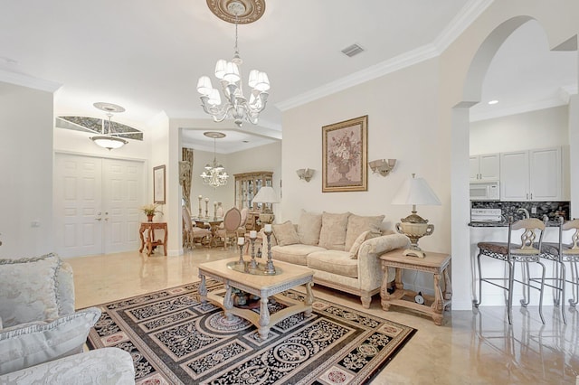 living room with crown molding and a chandelier