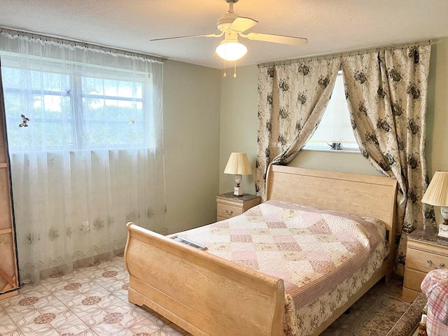 bedroom featuring a textured ceiling and ceiling fan