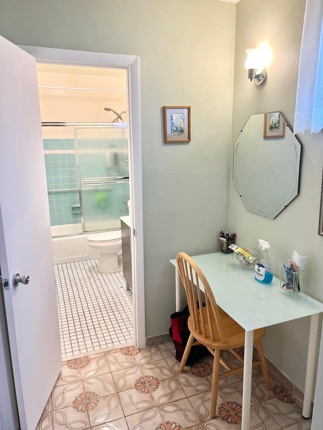 bathroom with shower / bath combination with glass door, tile patterned flooring, and toilet