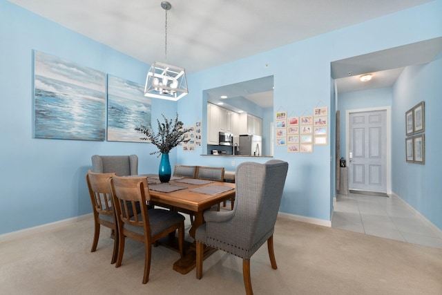 dining room with light carpet, baseboards, and light tile patterned flooring