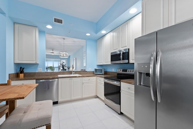 kitchen with visible vents, dark countertops, stainless steel appliances, a sink, and recessed lighting