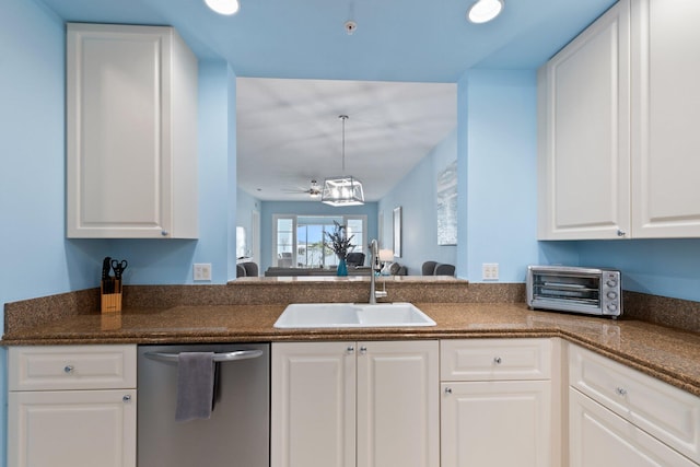 kitchen featuring white cabinets, a toaster, dishwasher, and a sink