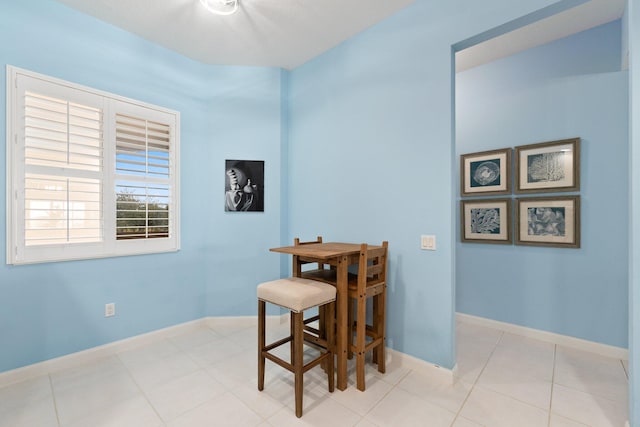 dining area with baseboards and tile patterned floors