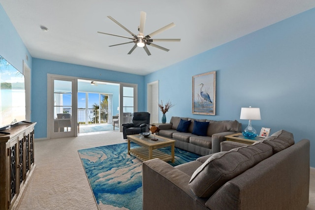 living area featuring carpet floors and ceiling fan