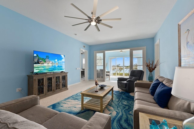 living room with carpet, baseboards, and ceiling fan