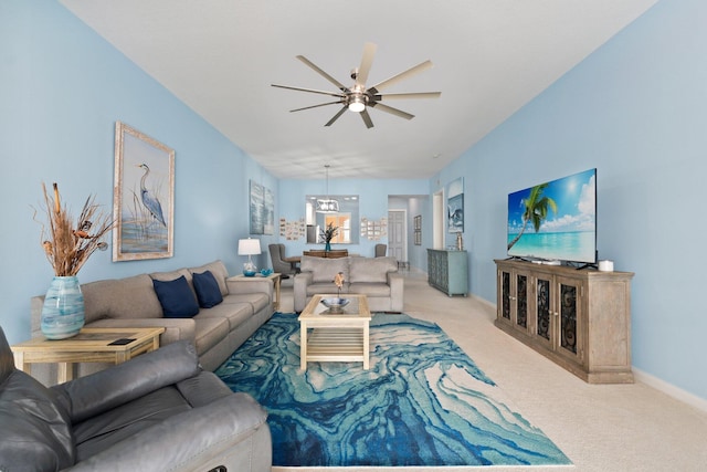 carpeted living room featuring a ceiling fan and baseboards