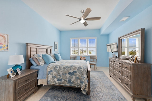 bedroom featuring light carpet, ceiling fan, visible vents, and baseboards