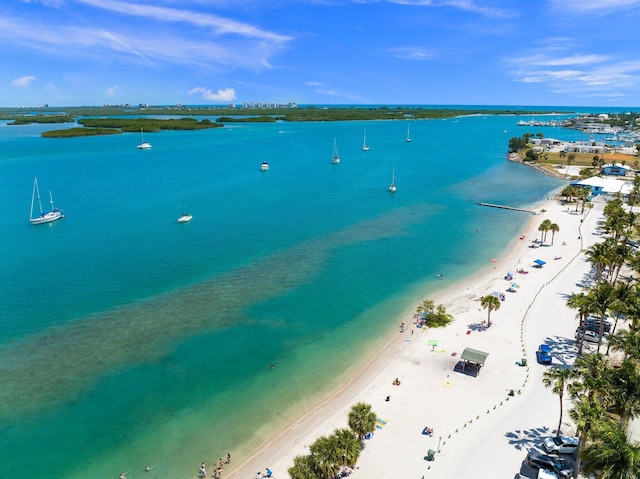 drone / aerial view featuring a beach view and a water view