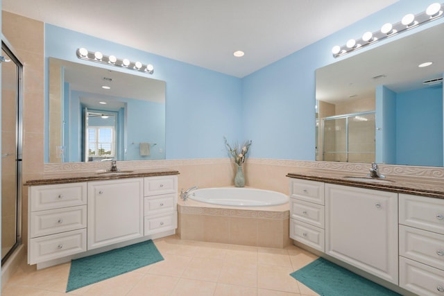 full bath with a stall shower, a sink, a bath, and tile patterned floors