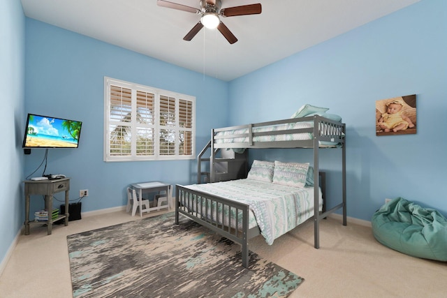 bedroom with ceiling fan, carpet, and baseboards