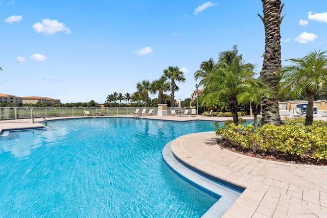 community pool featuring a patio area and fence