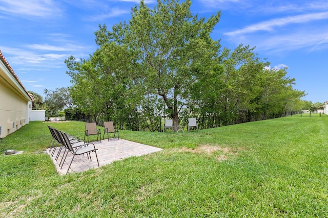 view of yard with fence and a patio