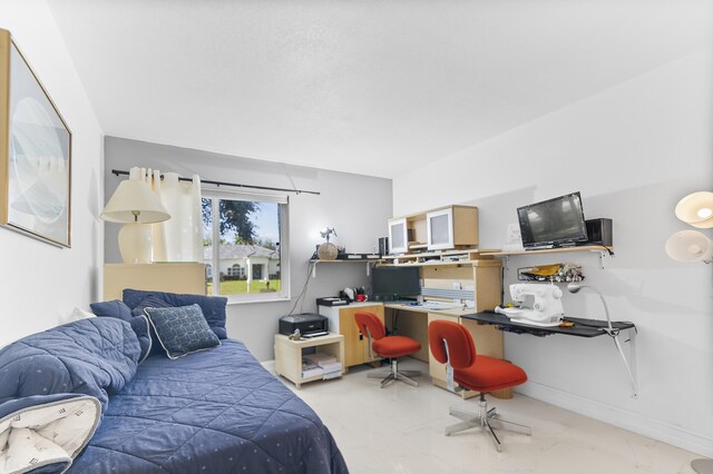 bedroom with a raised ceiling and ensuite bathroom