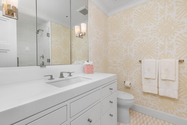 bathroom with ornamental molding, a tile shower, vanity, and toilet