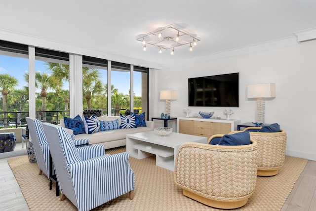 living room featuring a healthy amount of sunlight, crown molding, and expansive windows