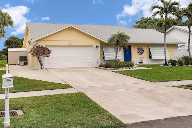 ranch-style house with a garage, a front yard, and central air condition unit