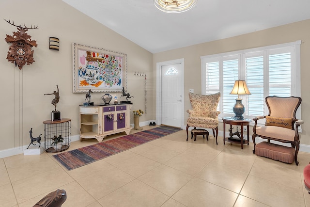 entryway with lofted ceiling and light tile patterned floors