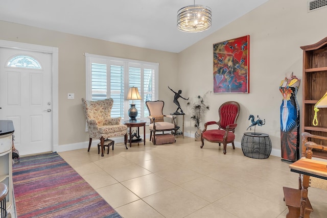 living area with lofted ceiling and light tile patterned floors