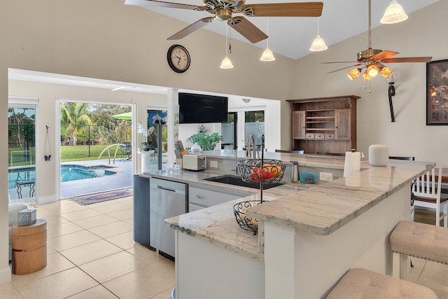 kitchen with pendant lighting, sink, ceiling fan, light tile patterned floors, and stainless steel dishwasher