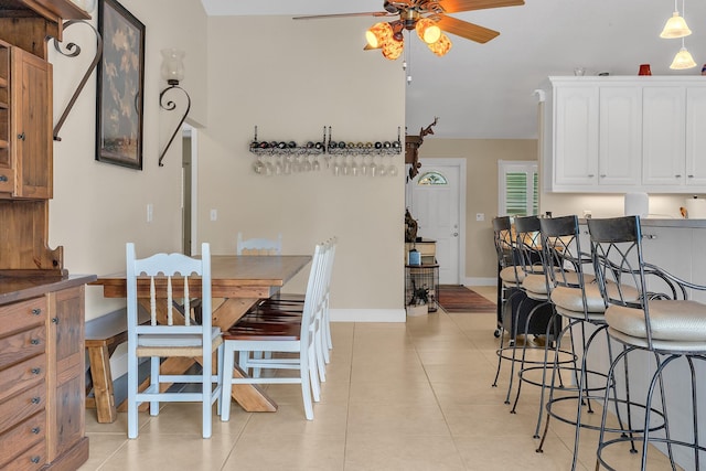 tiled dining area featuring ceiling fan