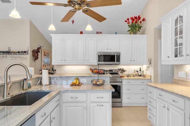 kitchen with pendant lighting, sink, light tile patterned floors, appliances with stainless steel finishes, and white cabinets