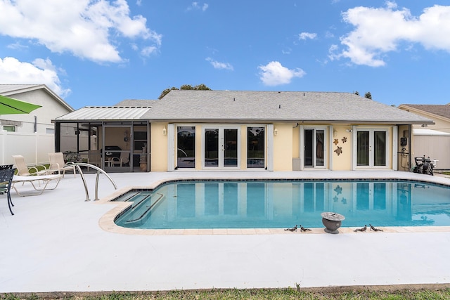 view of pool with a sunroom and a patio