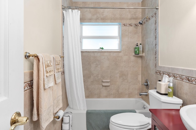 full bathroom featuring toilet, sink, tile walls, and shower / bath combo with shower curtain