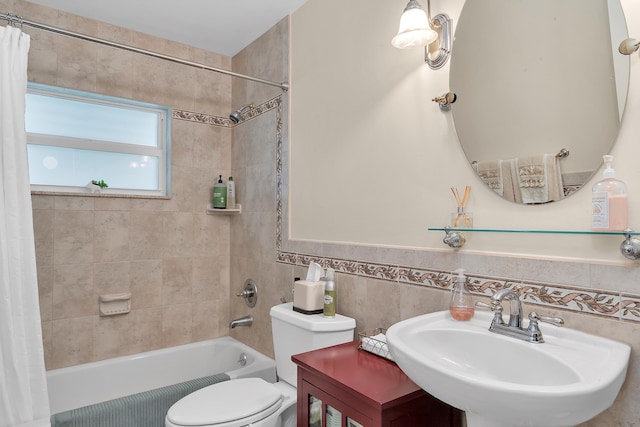 full bathroom featuring toilet, tile walls, sink, and shower / bath combo with shower curtain