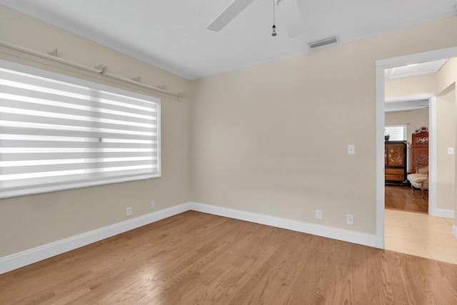 unfurnished room with ceiling fan and light hardwood / wood-style flooring