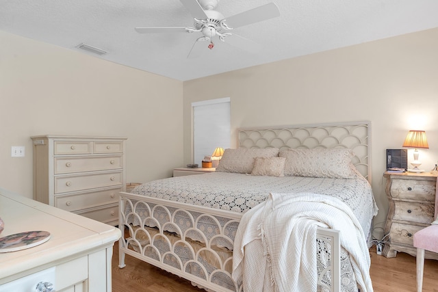 bedroom with ceiling fan and hardwood / wood-style flooring