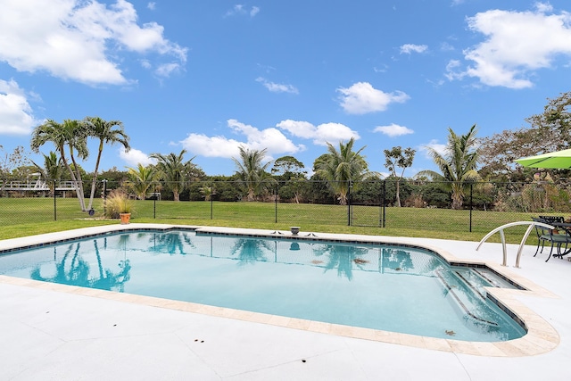 view of pool featuring a lawn