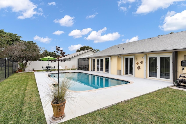 view of pool featuring a lawn, french doors, and a patio