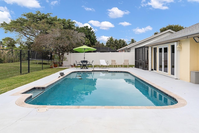 view of pool featuring a lawn and a patio area