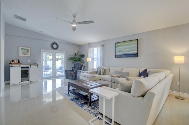 tiled living room featuring vaulted ceiling, wine cooler, ceiling fan, and french doors