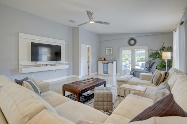 living room with ceiling fan and vaulted ceiling