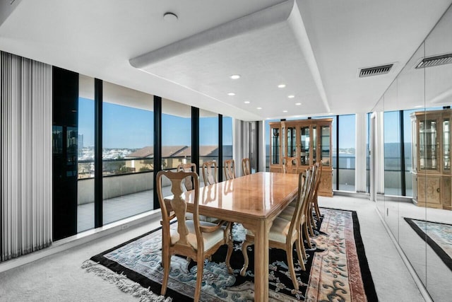 100 Lakeshore Dr Unit 252, North Palm Beach, FL 33408 - carpeted dining space with a wall of windows