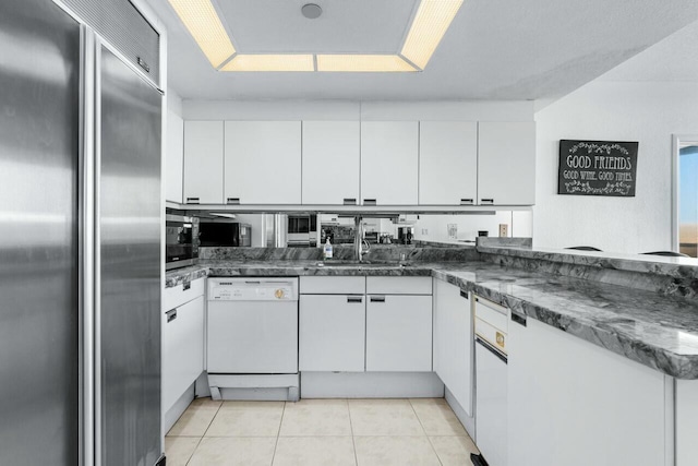 100 Lakeshore Dr Unit 252, North Palm Beach, FL 33408 - kitchen with white dishwasher, white cabinets, stainless steel built in refrigerator, and light tile patterned floors
