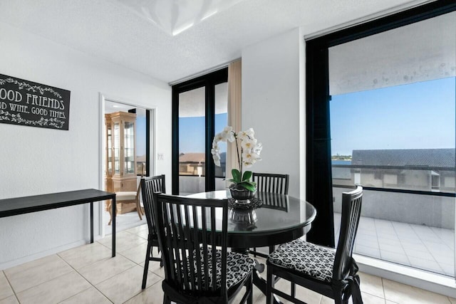 100 Lakeshore Dr Unit 252, North Palm Beach, FL 33408 - dining space featuring tile patterned flooring, a textured ceiling, expansive windows, and a water view