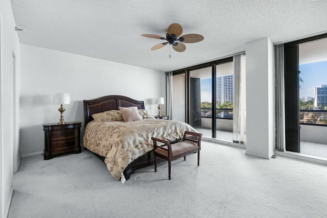 100 Lakeshore Dr Unit 252, North Palm Beach, FL 33408 - carpeted bedroom with access to outside, a textured ceiling, floor to ceiling windows, and ceiling fan