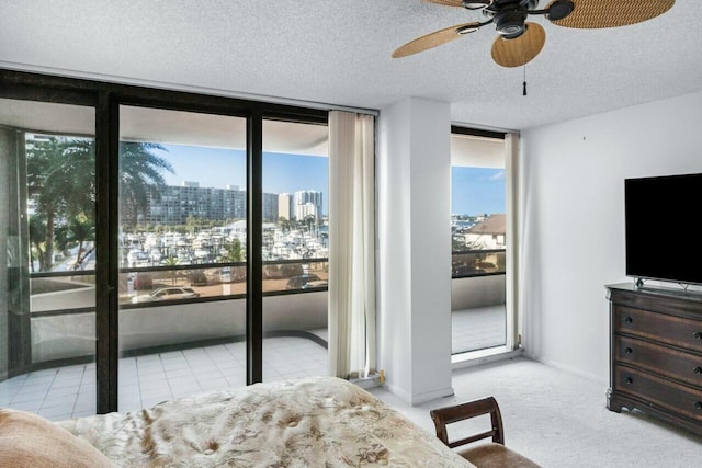 100 Lakeshore Dr Unit 252, North Palm Beach, FL 33408 - carpeted bedroom featuring access to outside, a textured ceiling, ceiling fan, and multiple windows