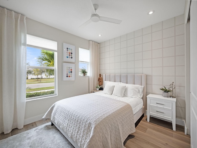 bedroom featuring ceiling fan and light hardwood / wood-style flooring