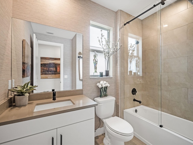 full bathroom with toilet, vanity, and shower / bath combination with glass door